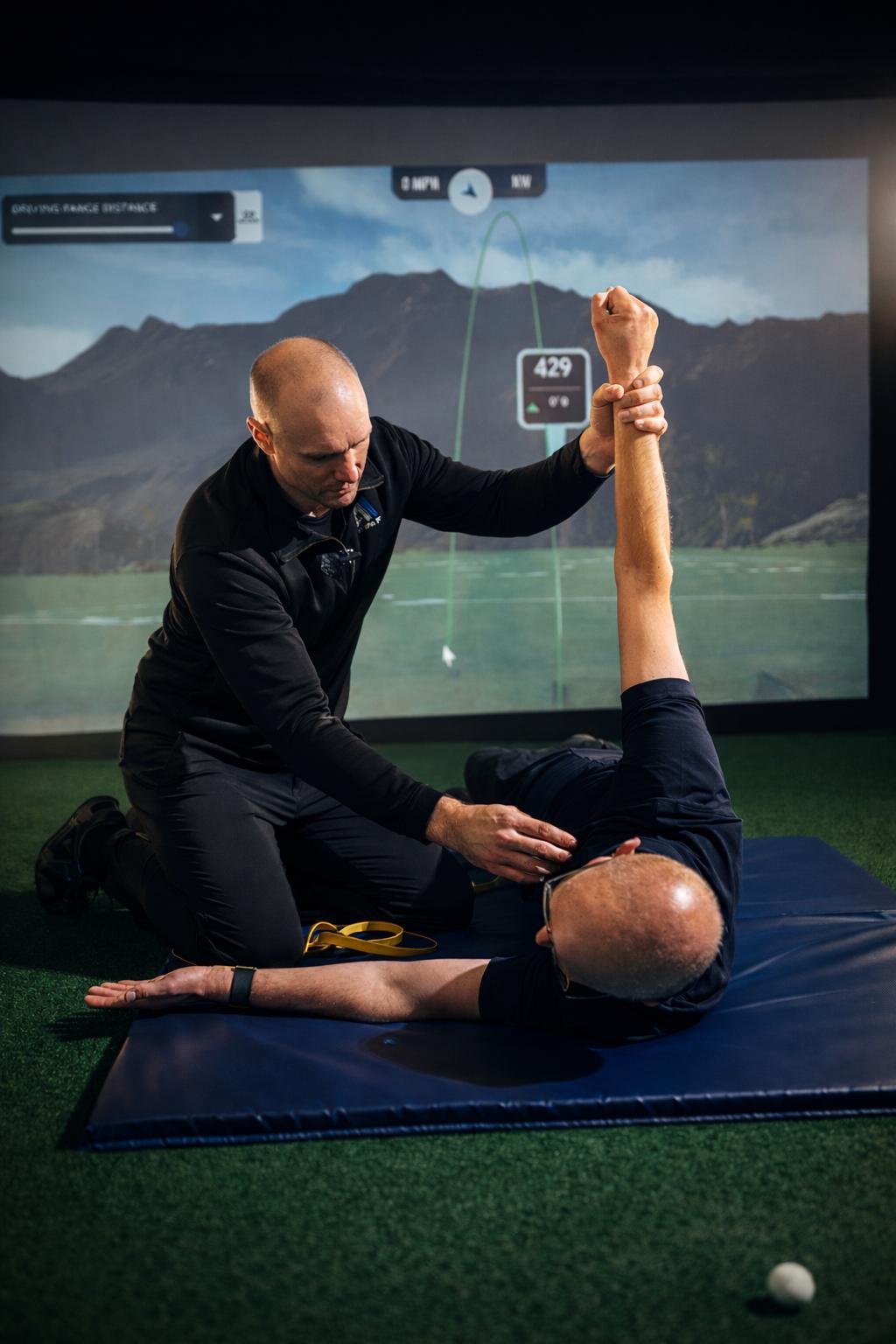 An Athlete1st coach screening a golfer in the studio.