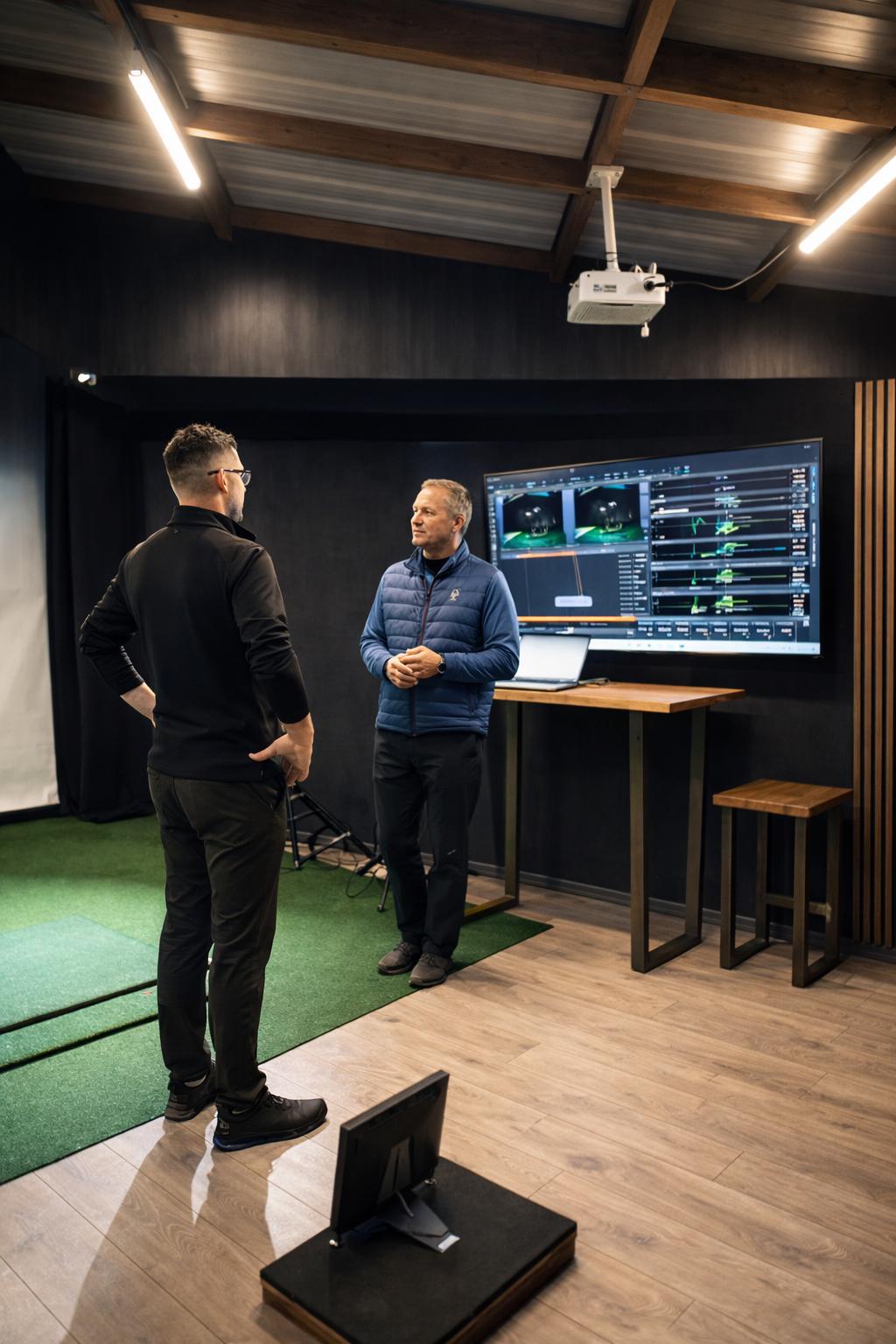 Two Athlete1st coaches reviewing an athlete's movement screen.